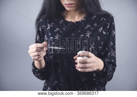 Young Ill Woman Hand Drug And Thermometer