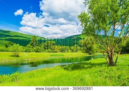 Beautiful Green Landscape, River Gacka Flowing Between The Meadow Fields In Lika Region Of Croatia