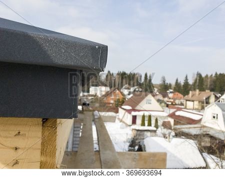 Close Up View Of Scaffolding And House Under Construction With Grey Folding Roof