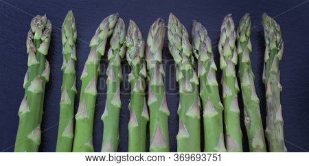 Asparagus Tips Against A Black Slate Background