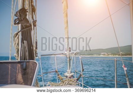 Sail Boat In Action In The Sea Going Out Of The Bay On Hot Summer Day