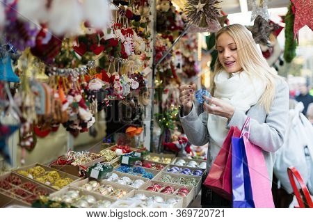Portrait Of 25s Female Customer Near Counter With Christmas Gifts