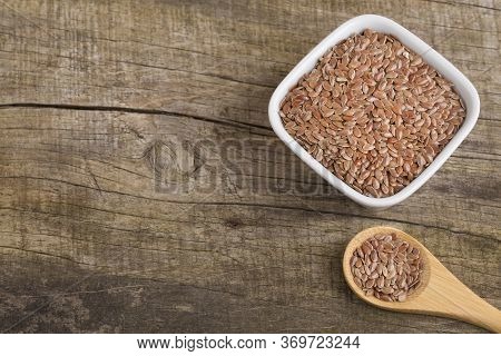 Linseed Organic Seeds - Linum Usitatissimum. Wood Background