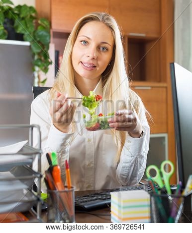 Smiling Young Woman Having Healthy Lunch At Office Desk