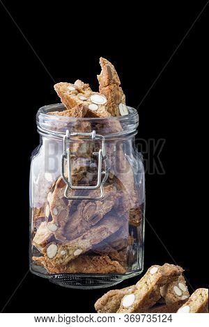 Italian Cantucci Almond Delicacy In A Glass Jar On A Black Background
