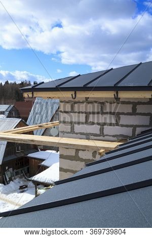 Close Up View Of House Under Construction With Grey Folding Roof On Waterproofing Layer