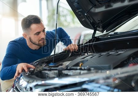 Happy Smiling Handsome Men In Shirt Looking At Opened Car Bonnet Before Successful Vehicle Buying. C