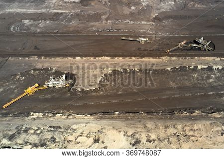 Aerial Shoot Of Quarry With Heavy Bucket Wheel Excavators Mining A Coal. Heavy Industry Concept.