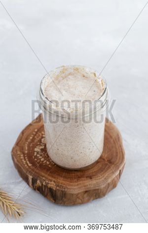 Close-up Of Jar With Natural Homemade Sourdough Levain Starter For Homemade Bakery
