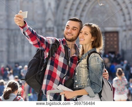 Happy Girl And Guy With Luggage Taking Selfie In City At Summer Day