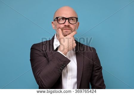 Thoughtful Mature Man Looking Up Feeling Skeptic Doubtful