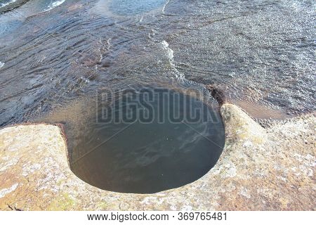 Rock Floor Bathed In Water From A Stream That Drills Large Holes Through The Years, Las Gachas, Guad