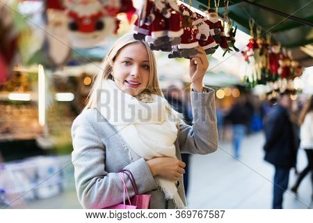Blonde Woman Shopping At Festive Fair Before Xmas
