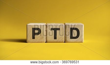 Ptd Text On A Yellow Background On Wooden Cubes