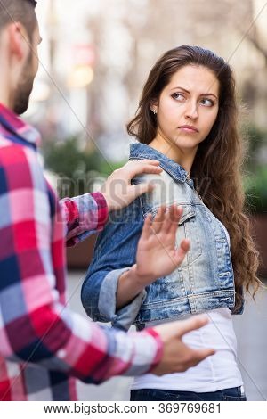 Male Person Accosting To Young Girl At Crowded Street