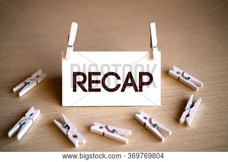 Recap - Text On A White Background On A Wooden Table With Lying Clothespin