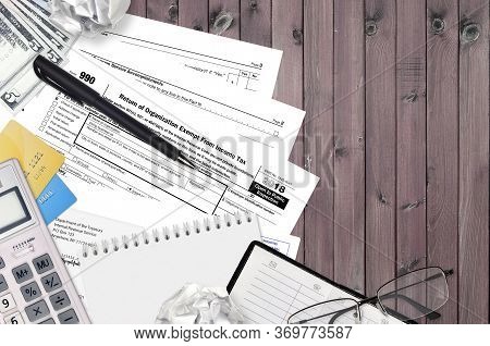Irs Form 990 Return Of Organization Exempt From Income Tax Lies On Flat Lay Office Table And Ready T