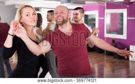 Adult Couples Enjoying Of Partner Dance And Smiling