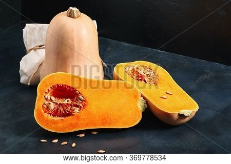 Nutmeg Pumpkin Dark Background. Concept Of Fresh Vegetables, Grocery Delivery, Eco-friendly Packagin