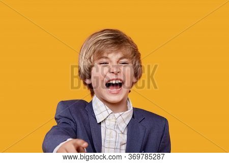 Laughing Boy Blond Points His Finger At The Camera. Ridicule
