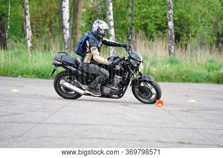 25-05-2020 Riga, Latvia. Motorcyclist Goes On Road. A Motorcyclist Learns To Control A Motorbike.