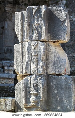 View Of The Ruins Of An Ancient Column With The Image On The Bas-relief Of A Wine Jug And A Vine
