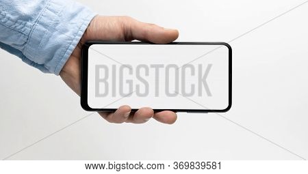 Male Hand Holding Smartphone With Blank Screen On White Background