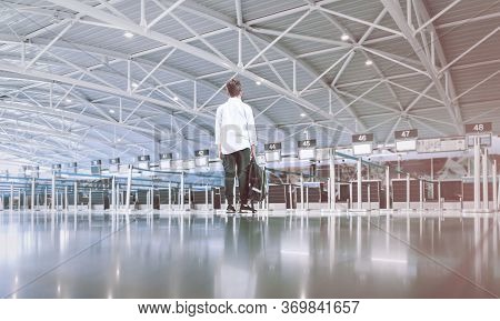 One Child Boy With Bckpack Alone At The Empty Deserted Airport Checkin Desk Waiting Area. Travel Fli