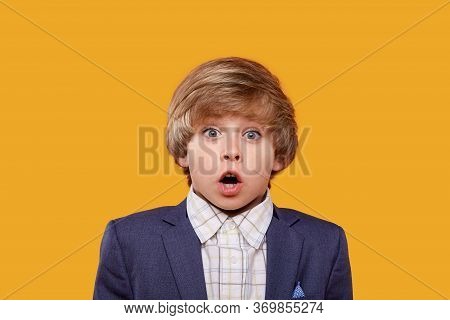 Surprised Boy Blond With His Mouth Open Looks Into The Camera.