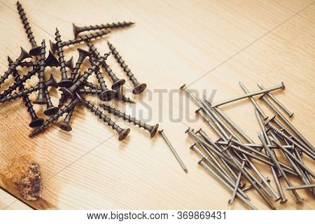 Screws And Nails On The Wood Bachground. Mock Up.