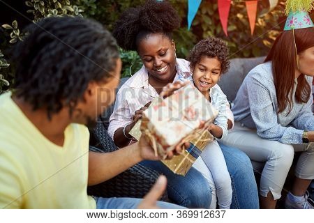 Father giving birthadays gift to his daughter
