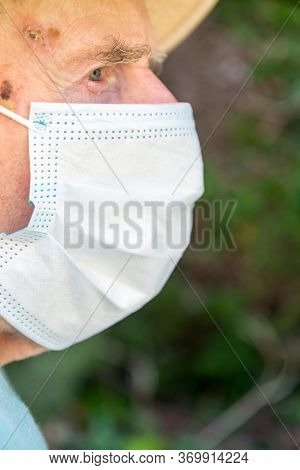 Elderly Man Wearing Face Mask As Coronavirus Protection,hampshire,united Kingdom.