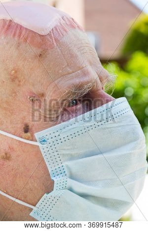 Elderly Man Wearing Face Mask As Coronavirus Protection,hampshire,united Kingdom.