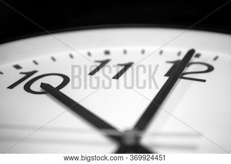 Closeup On The Pointers Of A Clock Marking A Few Seconds Before Ten O'clock - Black And White Render