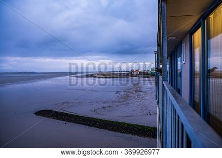 Delfzijl, Netherlands - January 11, 2020. View Of The Eemshotel Balcony To Ems River At Low Tide In 