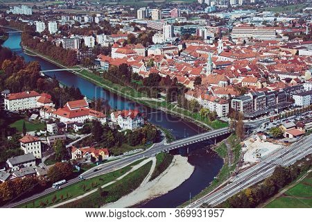 Aerial View To The City Celje In Slovenia. Red Roofs, River And The Bridge. Outdoor Travel Backgroun