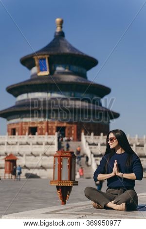 Brunette Girl Sitting On The Steps By Temple Of Heven In China