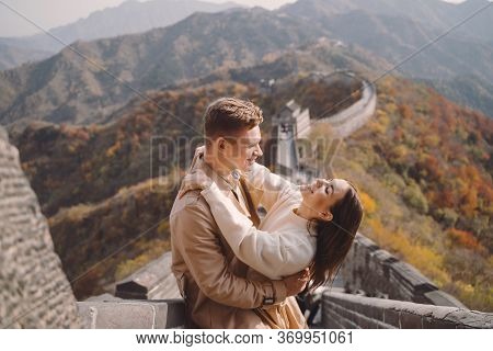 Beautiful Young Couple Showing Affection On The Great Wall Of China
