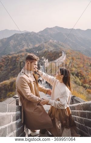 Beautiful Young Couple Showing Affection On The Great Wall Of China