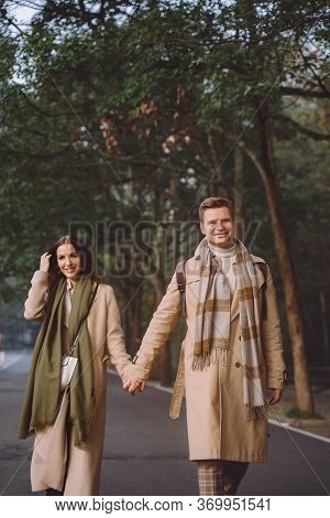 Newlywed Couple Showing Affection And Holding Hands As They Are Walking Through The Zhangjiajie Nati