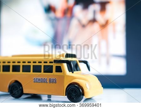 Yellow School Mini Bus Kids Toy, Student Transport For Children Transports Service On Blurred Agains