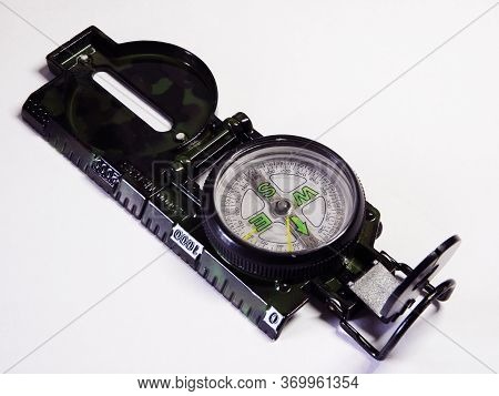Compass On A White Background Made Of Metal And With A Sight