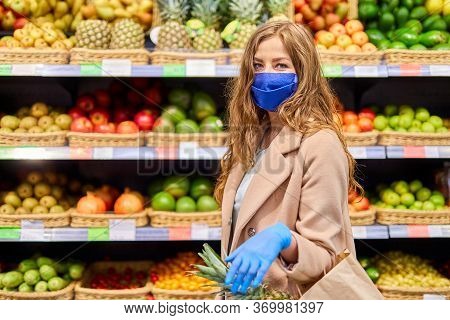 Healthy Fruits With Vitamins During The Coronavirus Covid-19 Pandemic. Woman In Facial Mask And Rubb