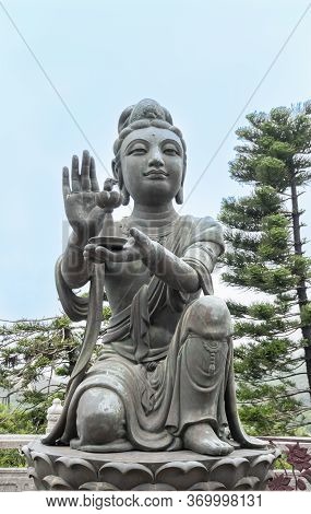 Buddhist Deva Statue Offering Gifts To The Tian Tan Big Buddha  Statue On Lantau Island, Hong Kong