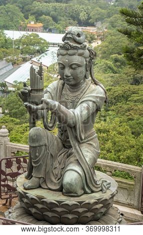 Buddhist Deva Statue Offering The Gift Of Music To The Tian Tan Big Buddha  Statue On Lantau Island,