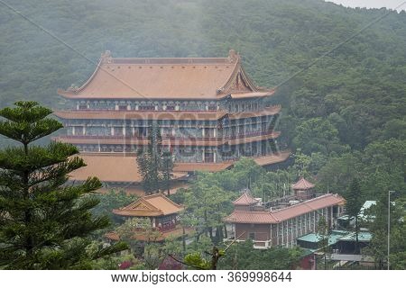 View Of Po Lin Monastery In The Mist In Ngong Ping Village On Lantau Island, Hong Kong