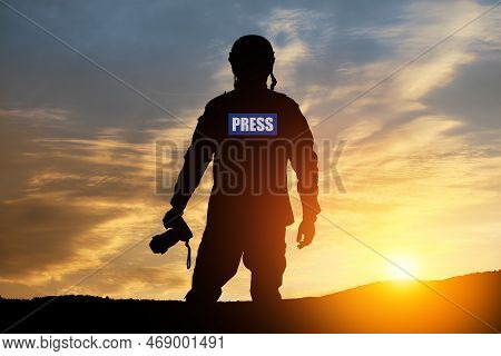 Photojournalist Silhouette Documenting War Or Conflict. Photojournalist At Sunset. War, Army, Techno