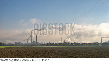 Chemical Industry With Large Chimneys In Frankfurt With Fields In Foreground