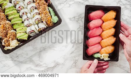 Flat Lay. Pre-packaged Variety Of Sushi And Sushi Rolls In A Plastic Tray.
