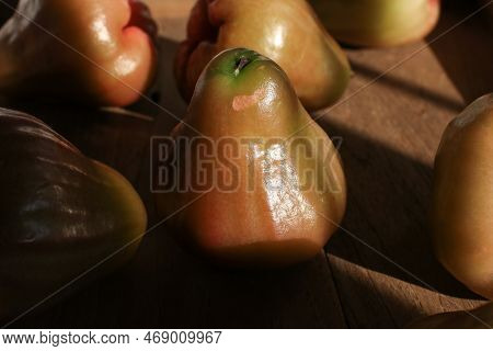 Close Up Rose Apple Or Jambu On Dark Background Under Sunlight. Thailand Apple Tropical Fruit Flavor